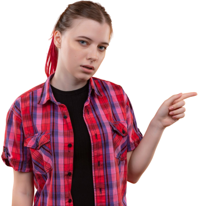 A young female student driver in a red plaid shirt pointing to the side, preparing for driving lessons for beginners in Toronto.